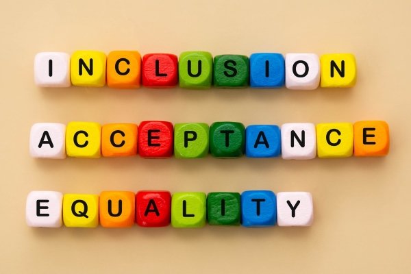 Colorful wooden blocks that spell out inclusion acceptance equality